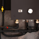 closeup plumbing connection water gas heater black colour