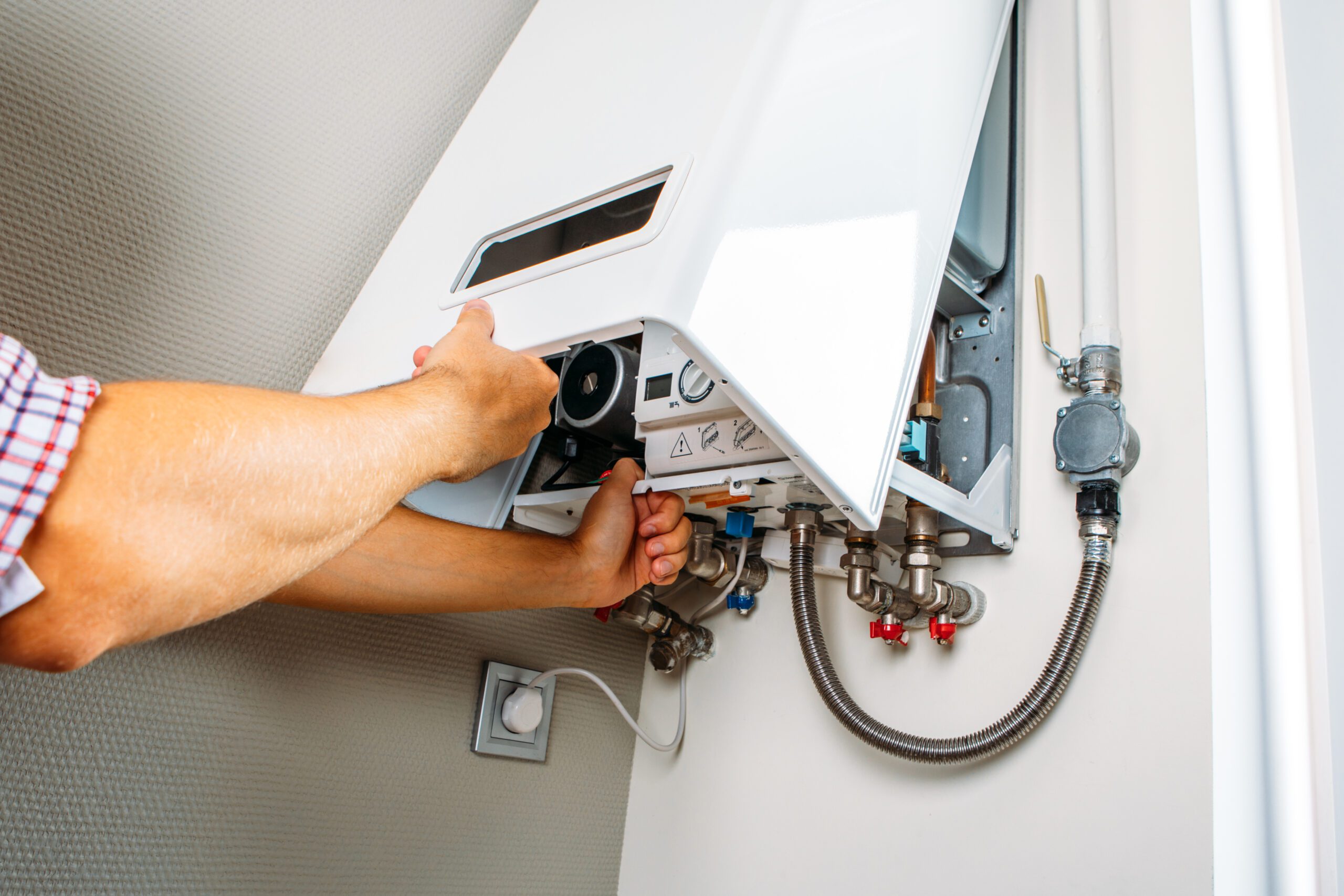 plumber attaches trying fix problem with residential heating equipment repair gas boiler scaled