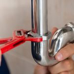 closeup-plumber-fixing-pipe-with-wrench