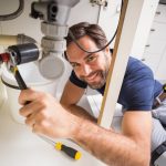 plumber-fixing-sink
